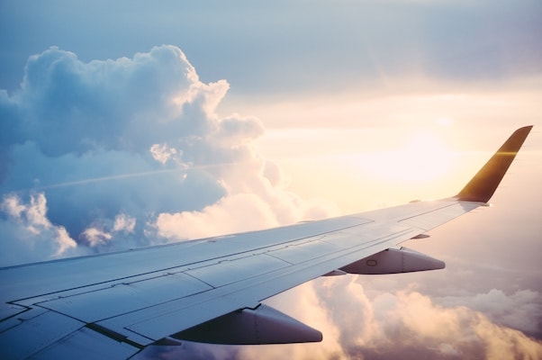 In image showing plane wing in clouds